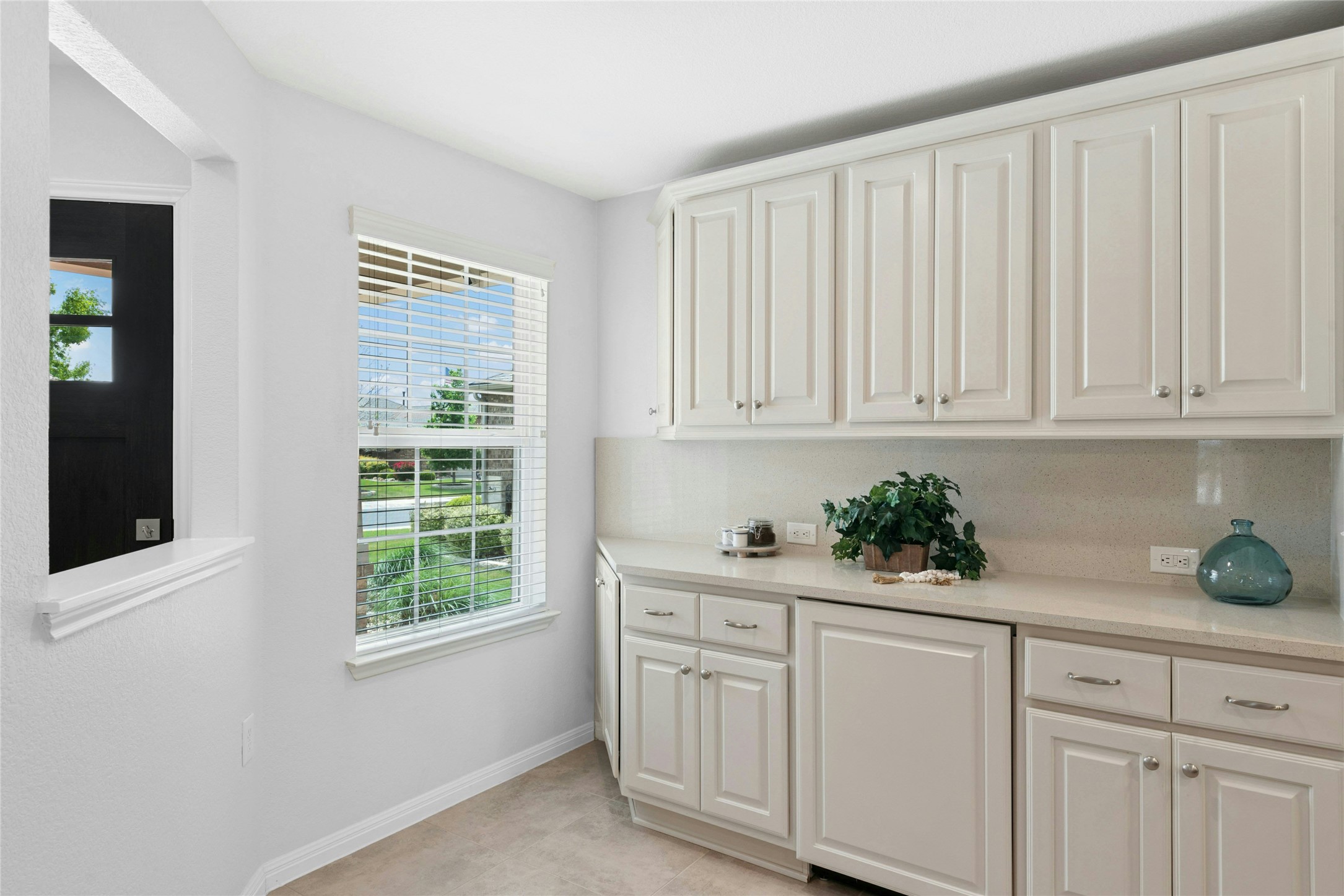 407 Fannin Court Georgetown, TX 78633 - Photo 13 of 40 a kitchen with white cabinets and window