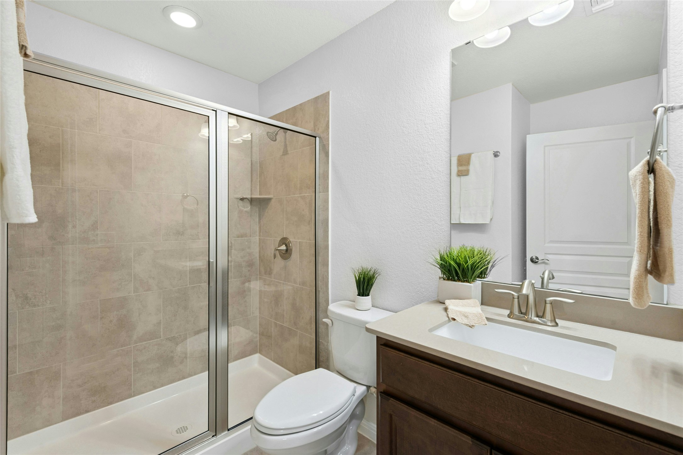 407 Fannin Court Georgetown, TX 78633 - Photo 21 of 40 a bathroom with a granite countertop sink toilet a large mirror a shower and a bathtub