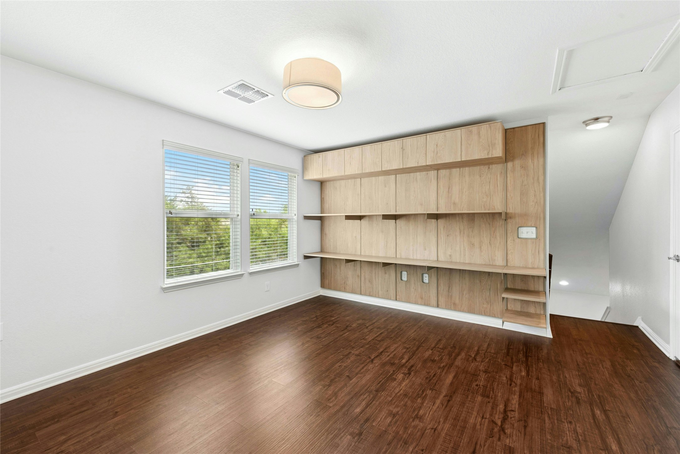 407 Fannin Court Georgetown, TX 78633 - Photo 23 of 40 a view of an empty room with wooden floor and a window
