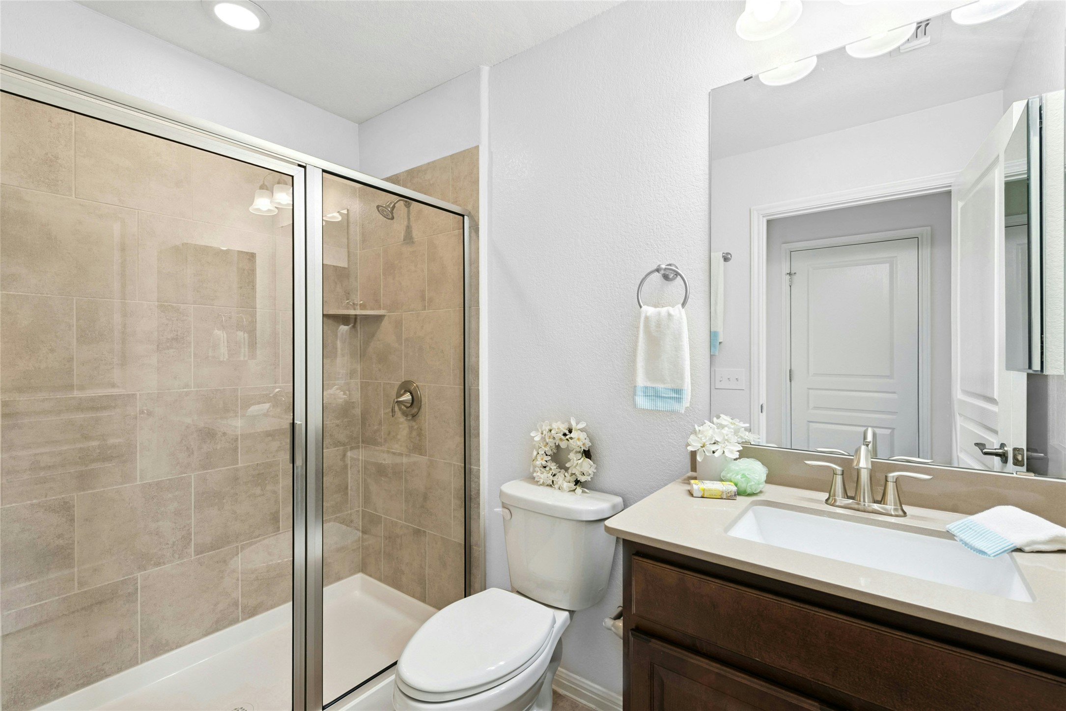407 Fannin Court Georgetown, TX 78633 - Photo 26 of 40 a bathroom with a granite countertop sink toilet a mirror a shower and vanity