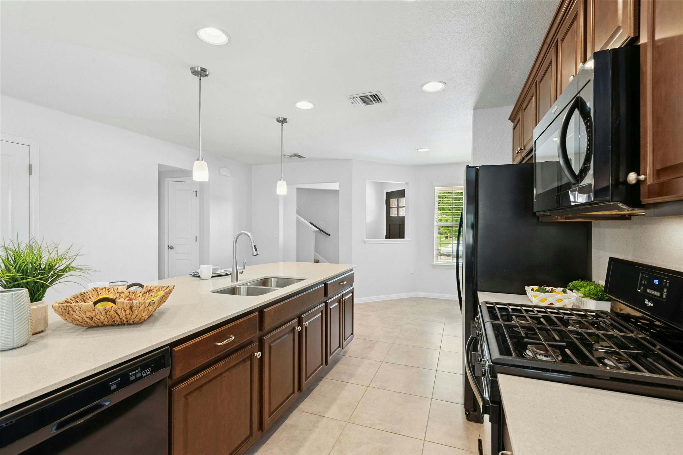 407 Fannin Court Georgetown, TX 78633 - Photo 10 of 40 a kitchen with stainless steel appliances a stove a sink a refrigerator and wooden cabinets