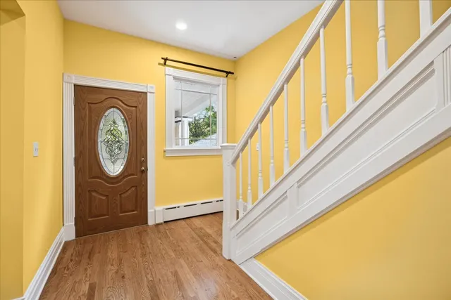a view of an entryway with wooden floor
