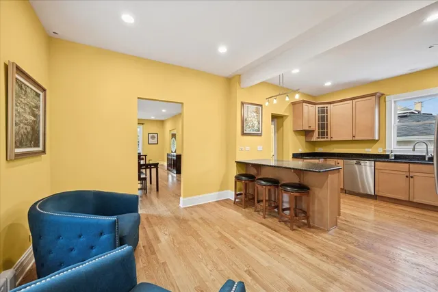 a living room with stainless steel appliances kitchen island granite countertop furniture and a kitchen view