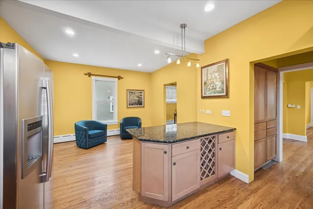 a kitchen with stainless steel appliances granite countertop a sink and a refrigerator