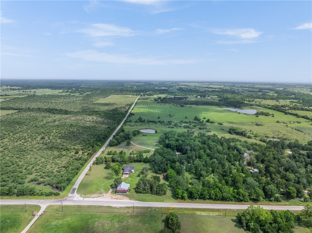 2250 Dillard Road Washington, TX 77880 - Photo 6 of 50 a view of a lush green outdoor space with a swimming pool and valleys in the background