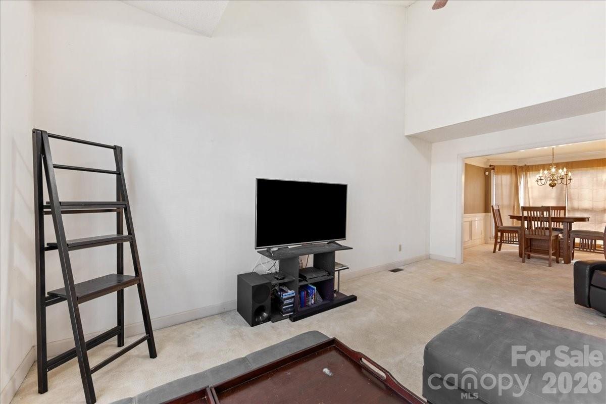 4107 Brownes Ferry Road Charlotte, NC 28269 - Photo 11 of 42 a living room with furniture and a flat screen tv