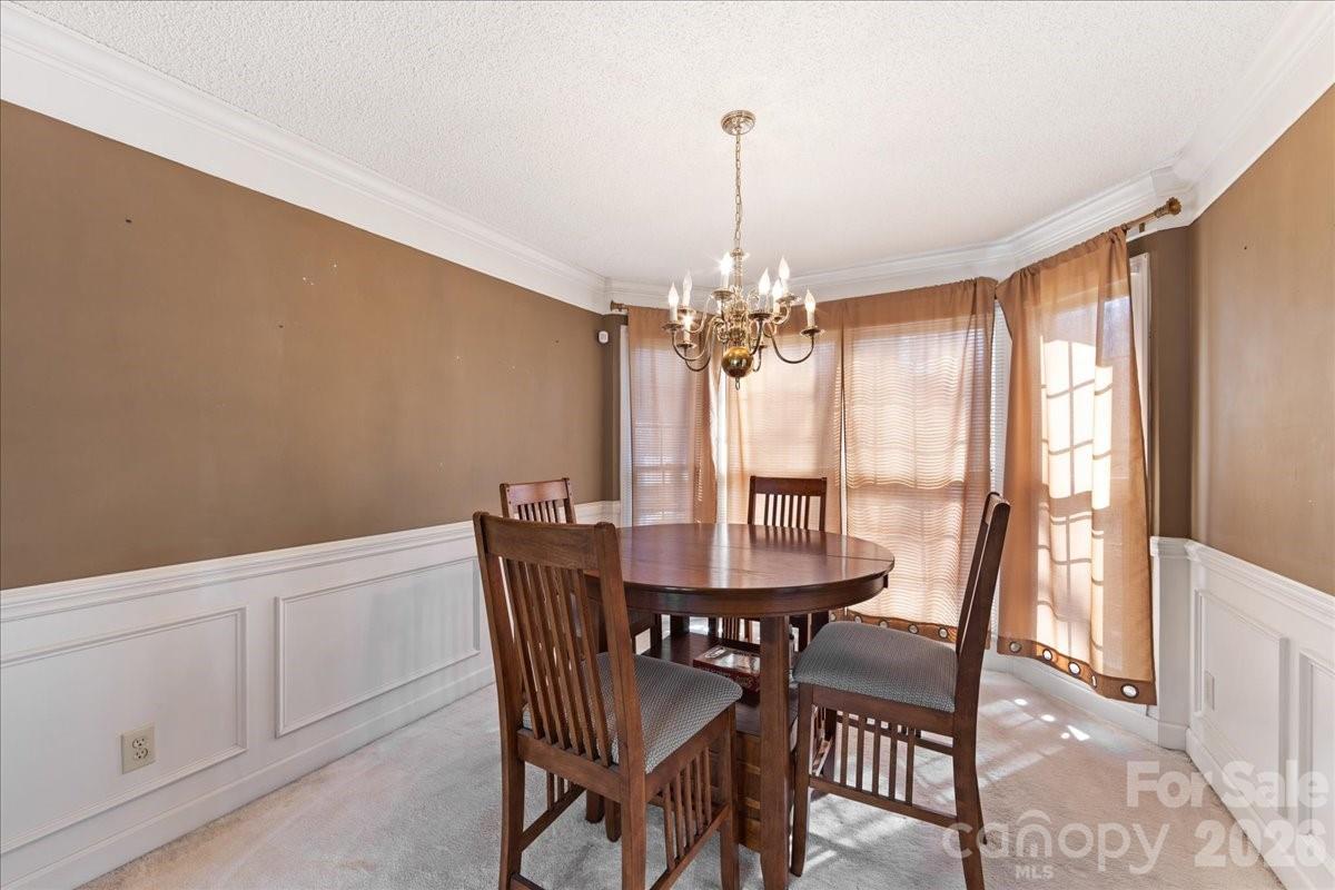 4107 Brownes Ferry Road Charlotte, NC 28269 - Photo 13 of 42 a view of a dining room with furniture and window