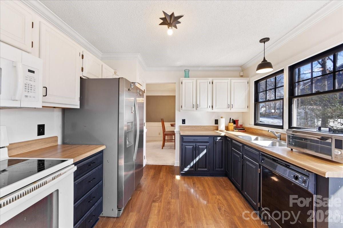 4107 Brownes Ferry Road Charlotte, NC 28269 - Photo 15 of 42 a kitchen with stainless steel appliances granite countertop a sink stove and refrigerator