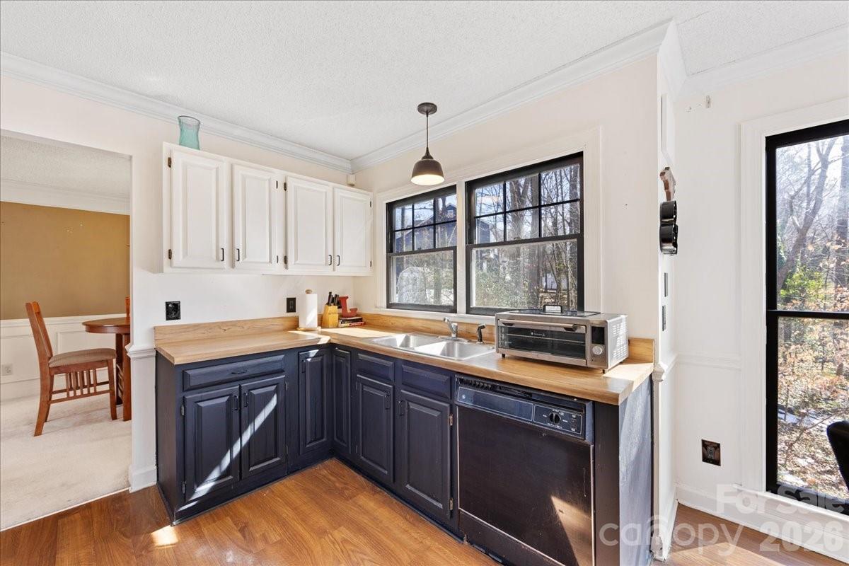 4107 Brownes Ferry Road Charlotte, NC 28269 - Photo 16 of 42 a kitchen with a sink stove and cabinets