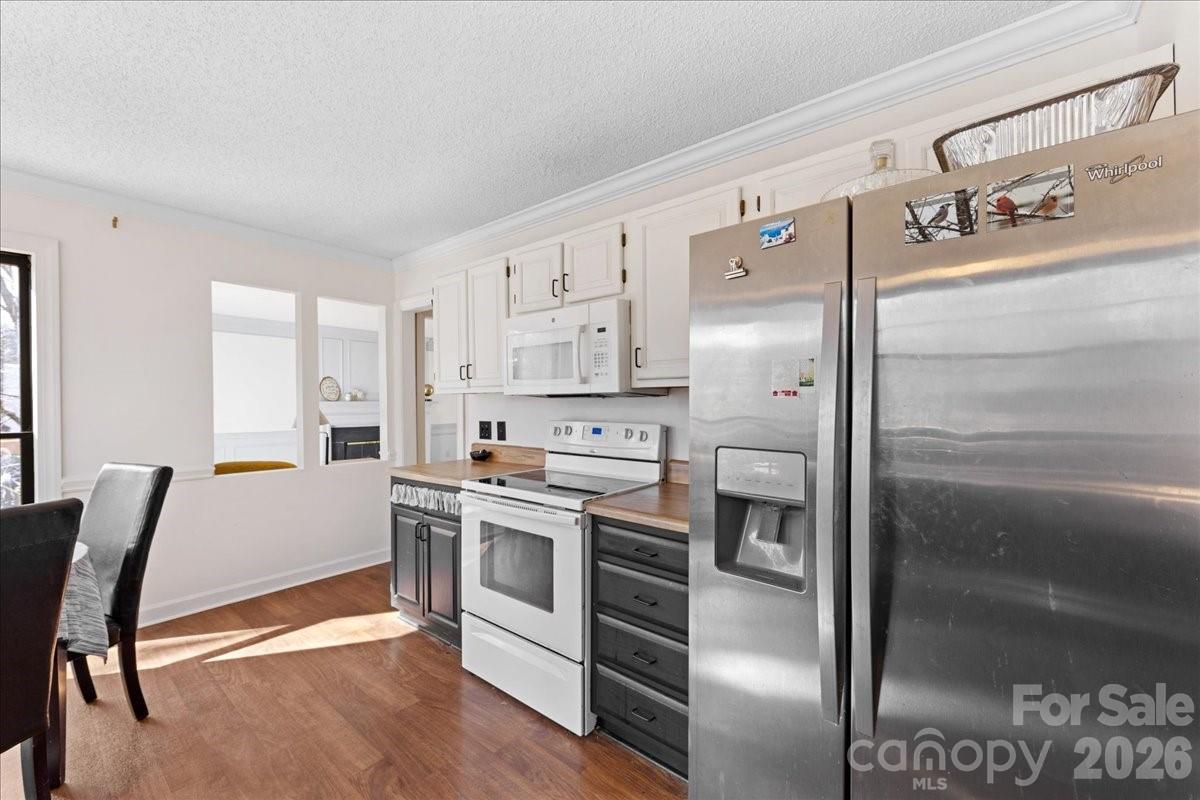 4107 Brownes Ferry Road Charlotte, NC 28269 - Photo 18 of 42 a kitchen with stainless steel appliances a stove a sink and a refrigerator