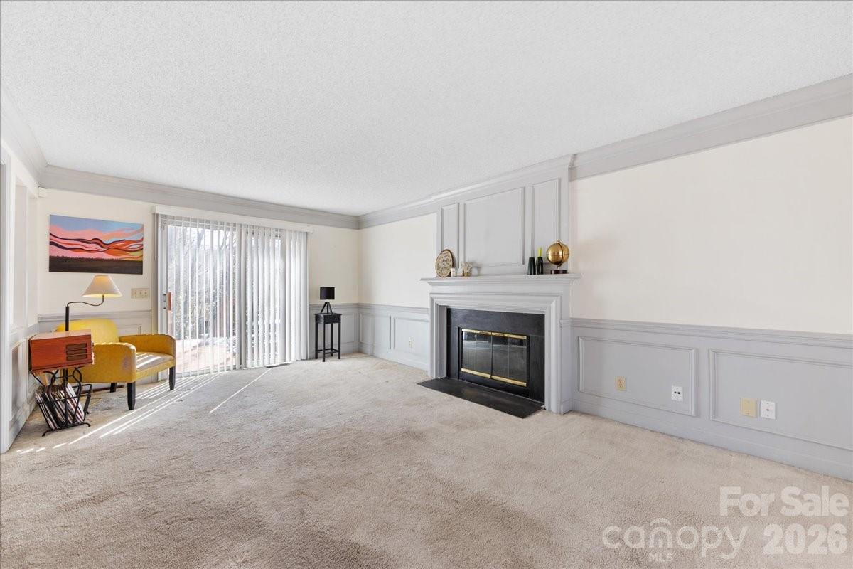 4107 Brownes Ferry Road Charlotte, NC 28269 - Photo 21 of 42 a spacious bedroom with furniture and a fireplace