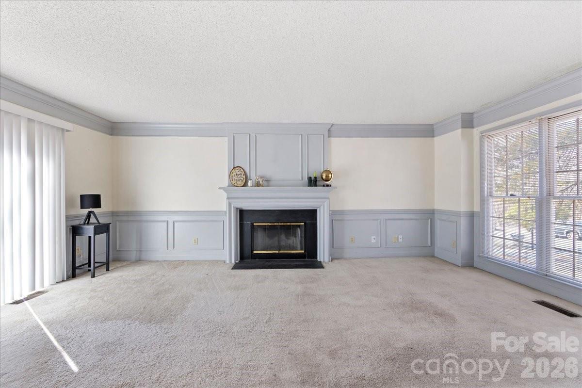 4107 Brownes Ferry Road Charlotte, NC 28269 - Photo 22 of 42 a view of an empty room with a fireplace and a window