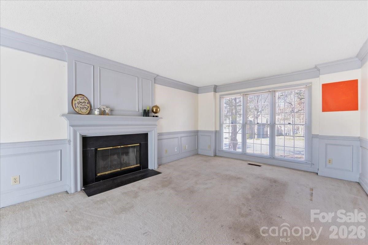 4107 Brownes Ferry Road Charlotte, NC 28269 - Photo 23 of 42 a view of an empty room with a fireplace