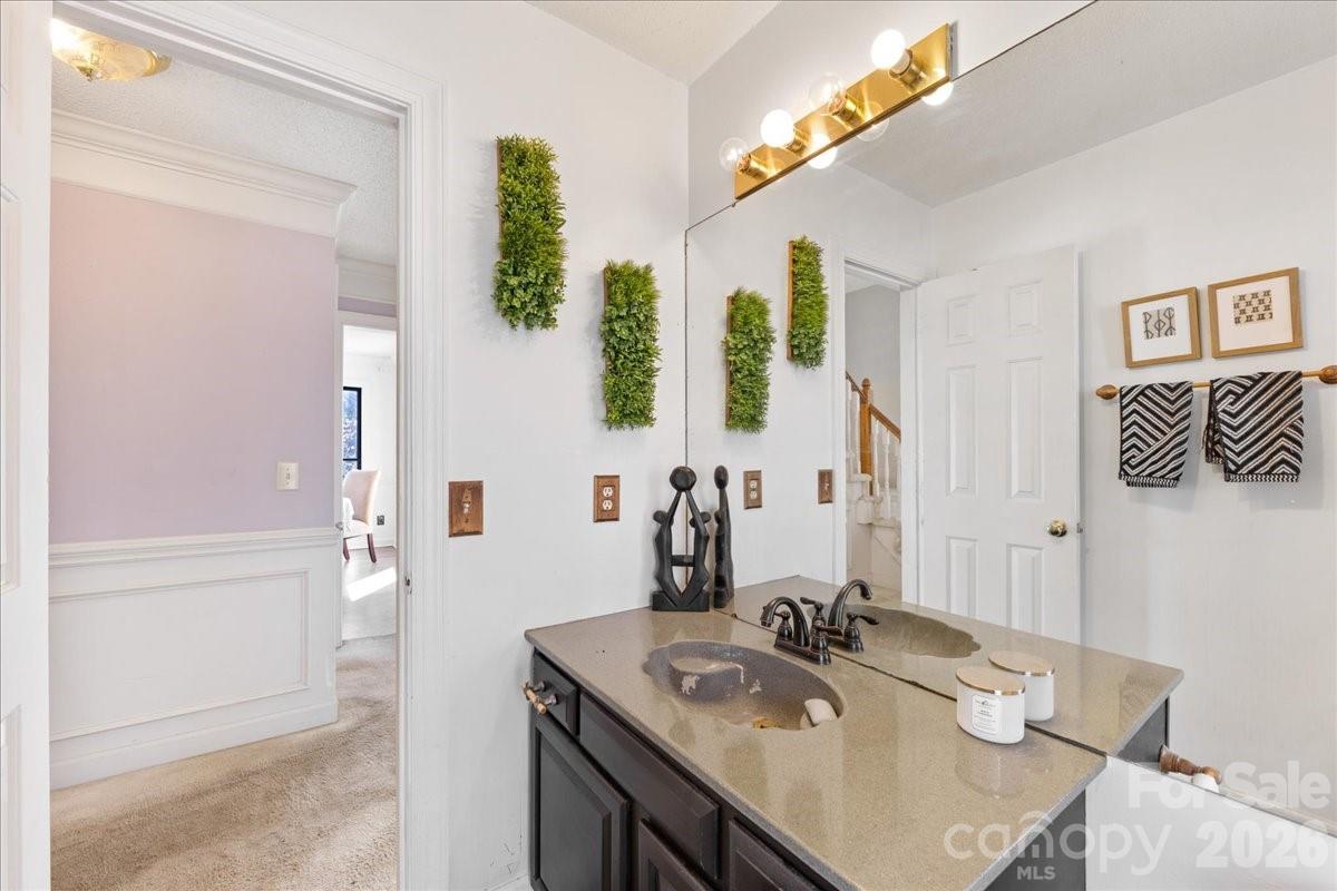 4107 Brownes Ferry Road Charlotte, NC 28269 - Photo 25 of 42 a bathroom with a sink vanity and a mirror