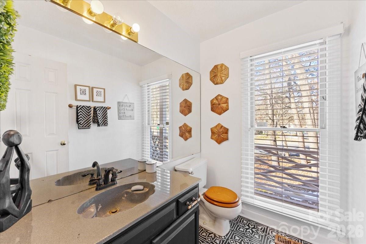 4107 Brownes Ferry Road Charlotte, NC 28269 - Photo 26 of 42 a bathroom with a sink toilet and a mirror