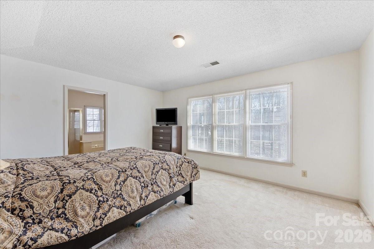 4107 Brownes Ferry Road Charlotte, NC 28269 - Photo 29 of 42 a spacious bedroom with a large bed and a window