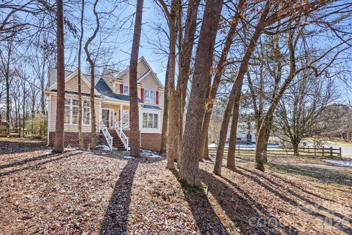 4107 Brownes Ferry Road Charlotte, NC 28269 - Photo 3 of 42 a front view of a house with a yard