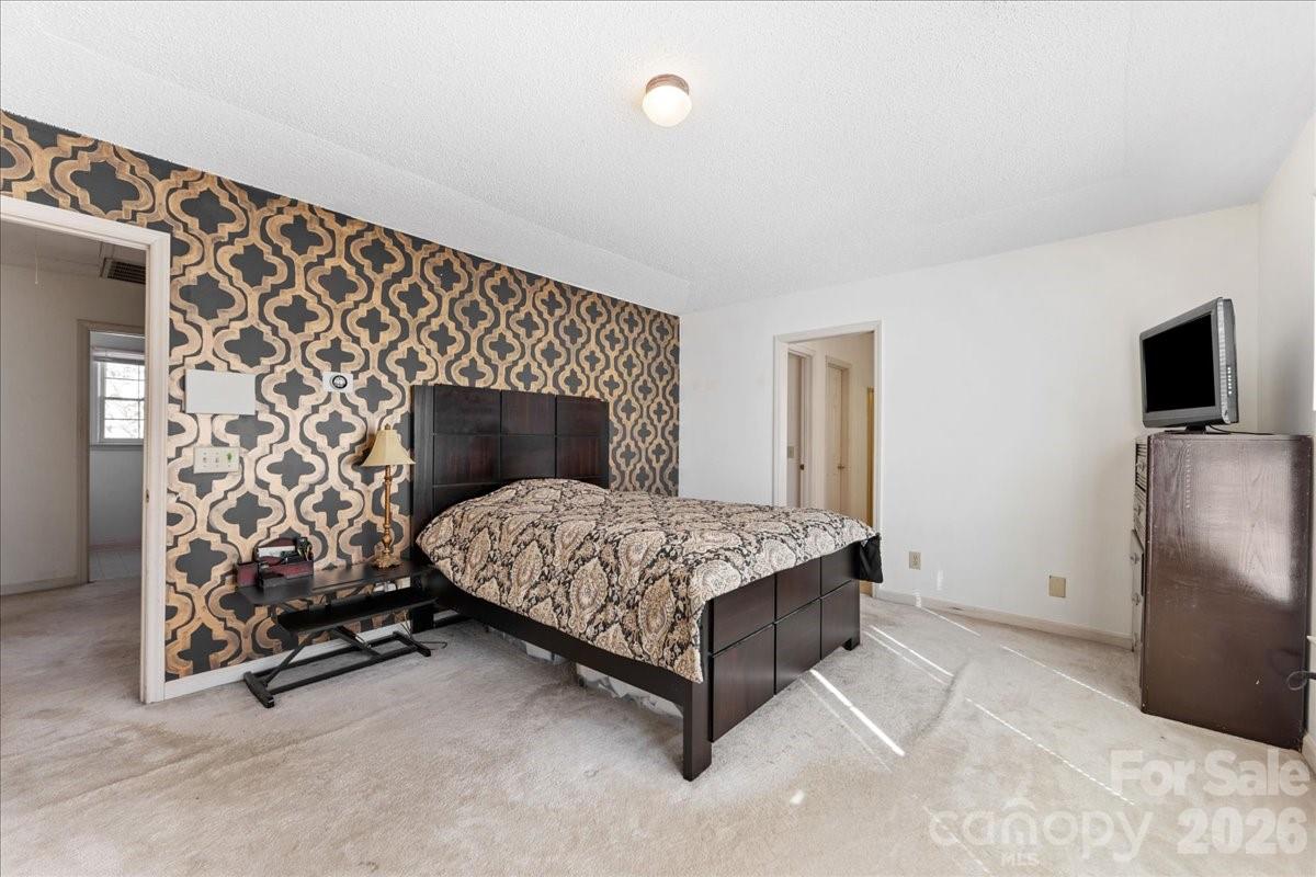 4107 Brownes Ferry Road Charlotte, NC 28269 - Photo 31 of 42 a bedroom with a bed and a tv