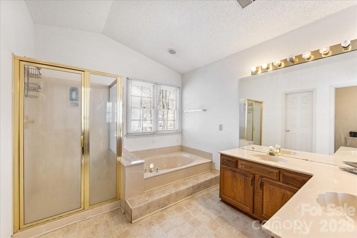 4107 Brownes Ferry Road Charlotte, NC 28269 - Photo 32 of 42 a spacious bathroom with a tub sink and mirror