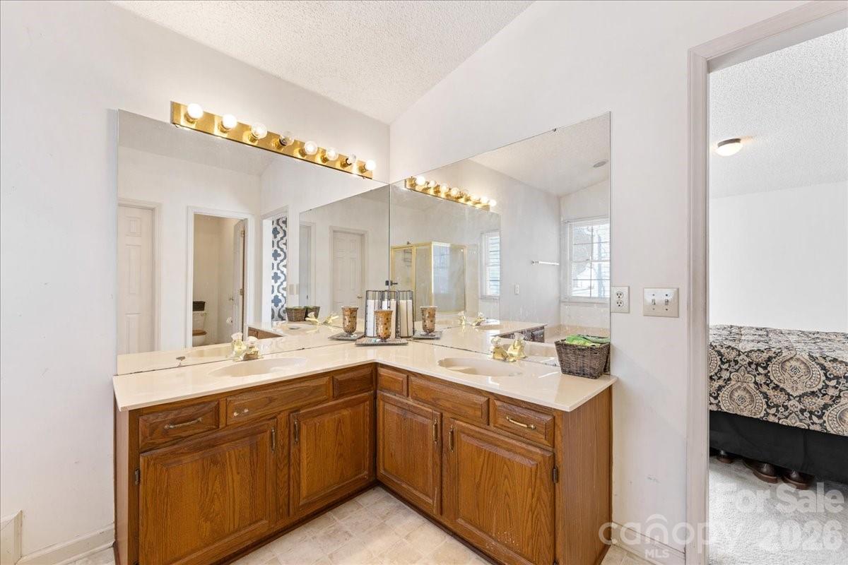 4107 Brownes Ferry Road Charlotte, NC 28269 - Photo 34 of 42 a bathroom with a sink double vanity and a mirror