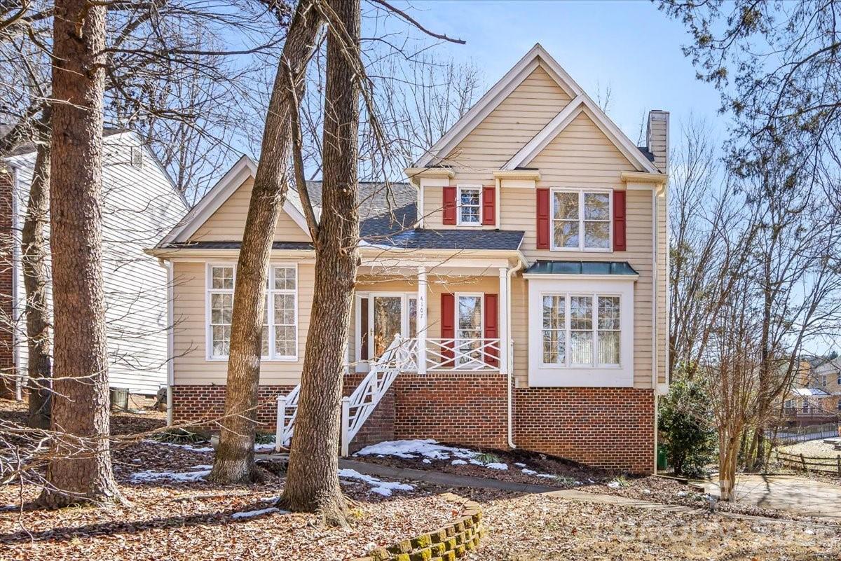 4107 Brownes Ferry Road Charlotte, NC 28269 - Photo 4 of 42 a front view of a house with a yard