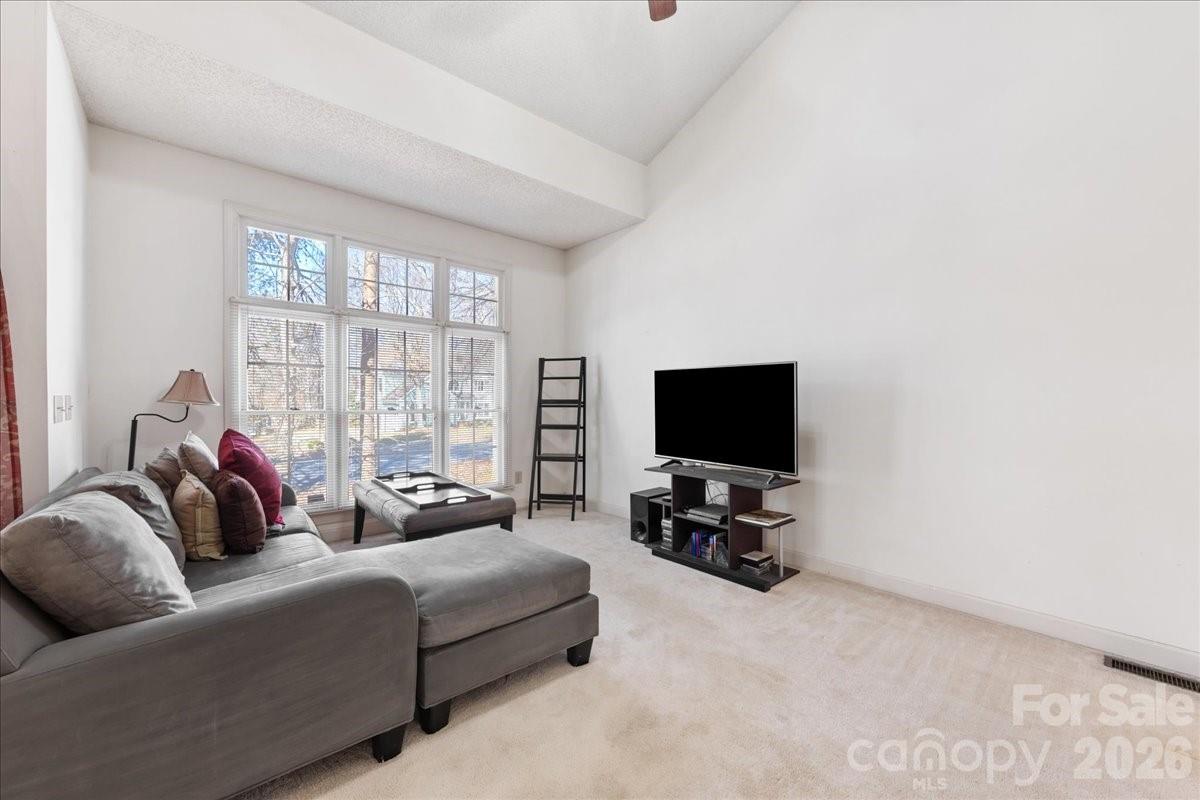 4107 Brownes Ferry Road Charlotte, NC 28269 - Photo 10 of 42 a living room with furniture and a flat screen tv