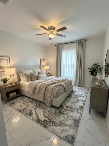 a bedroom with a large bed and a chandelier