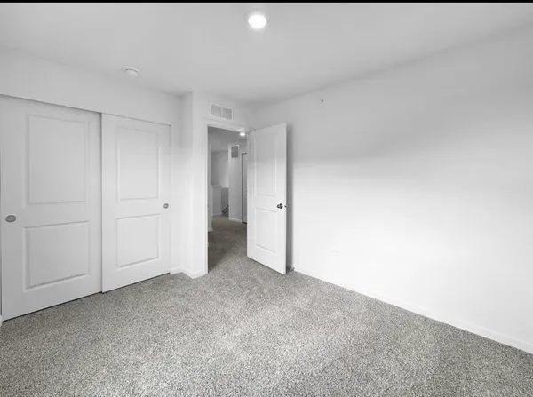 a bathroom with a granite countertop sink a toilet and shower