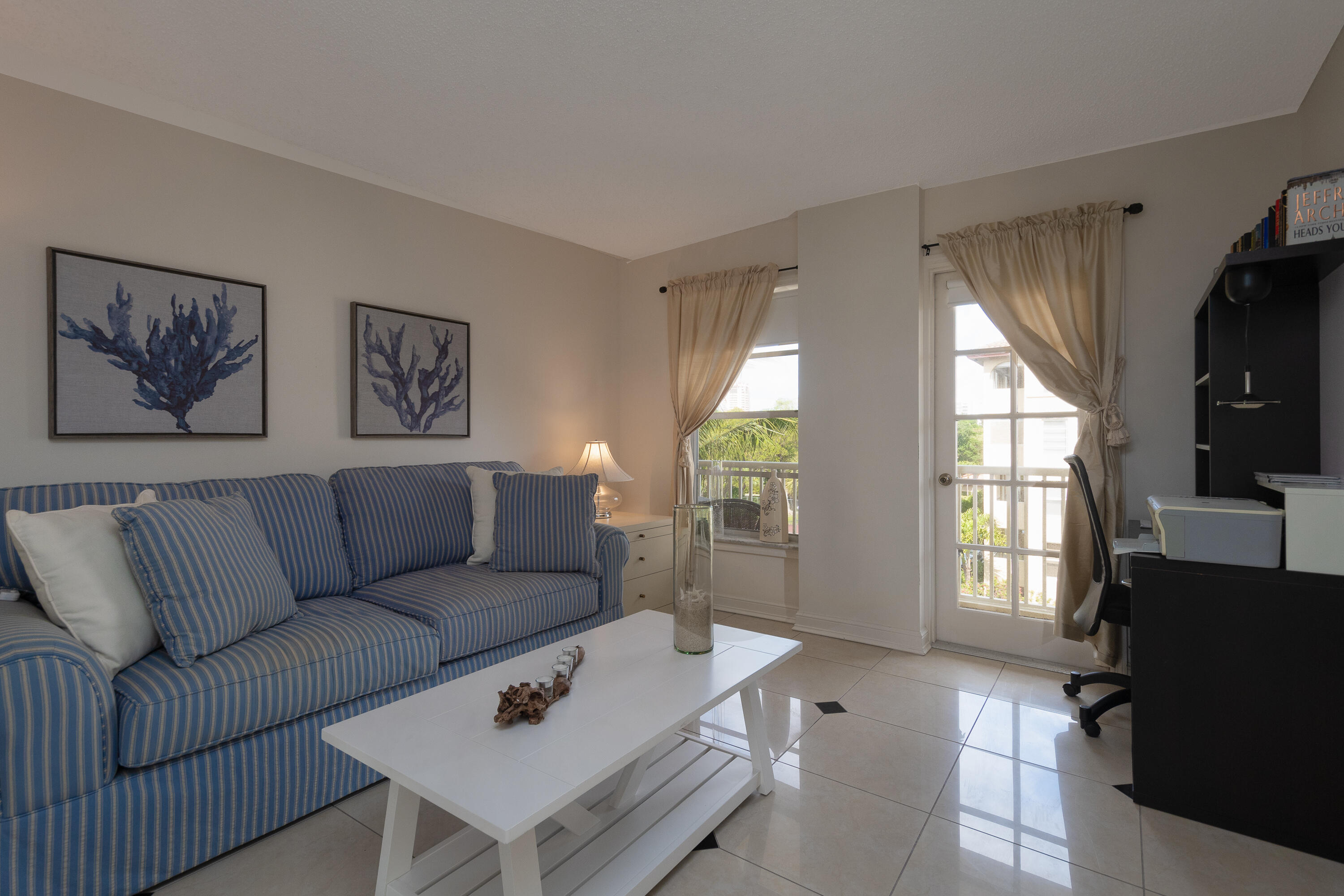 951 De Soto Road, Unit 427 Boca Raton, FL 33432 - Photo 11 of 44 a living room with furniture and a flat screen tv