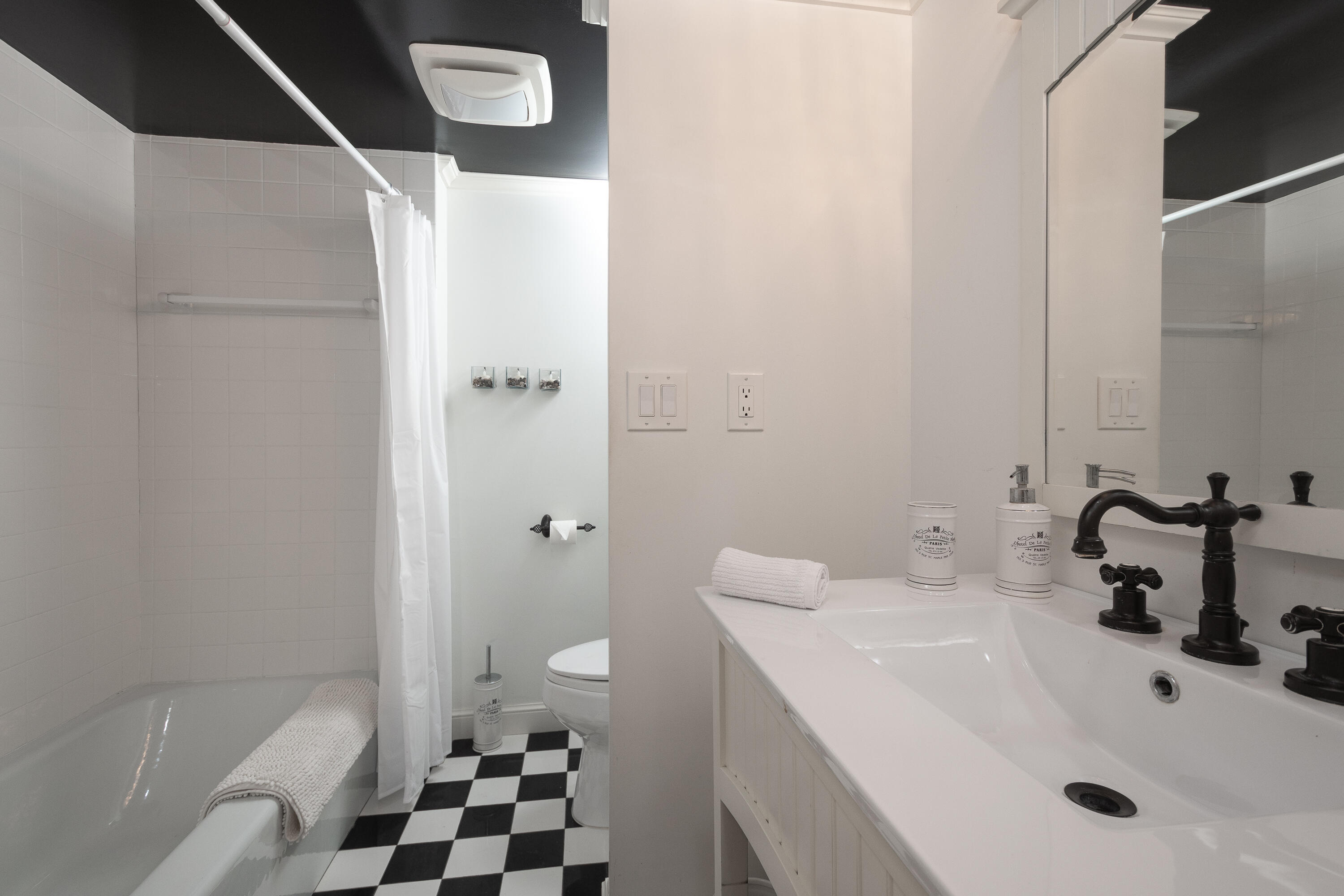 951 De Soto Road, Unit 427 Boca Raton, FL 33432 - Photo 13 of 44 a bathroom with a sink and mirror with toilet