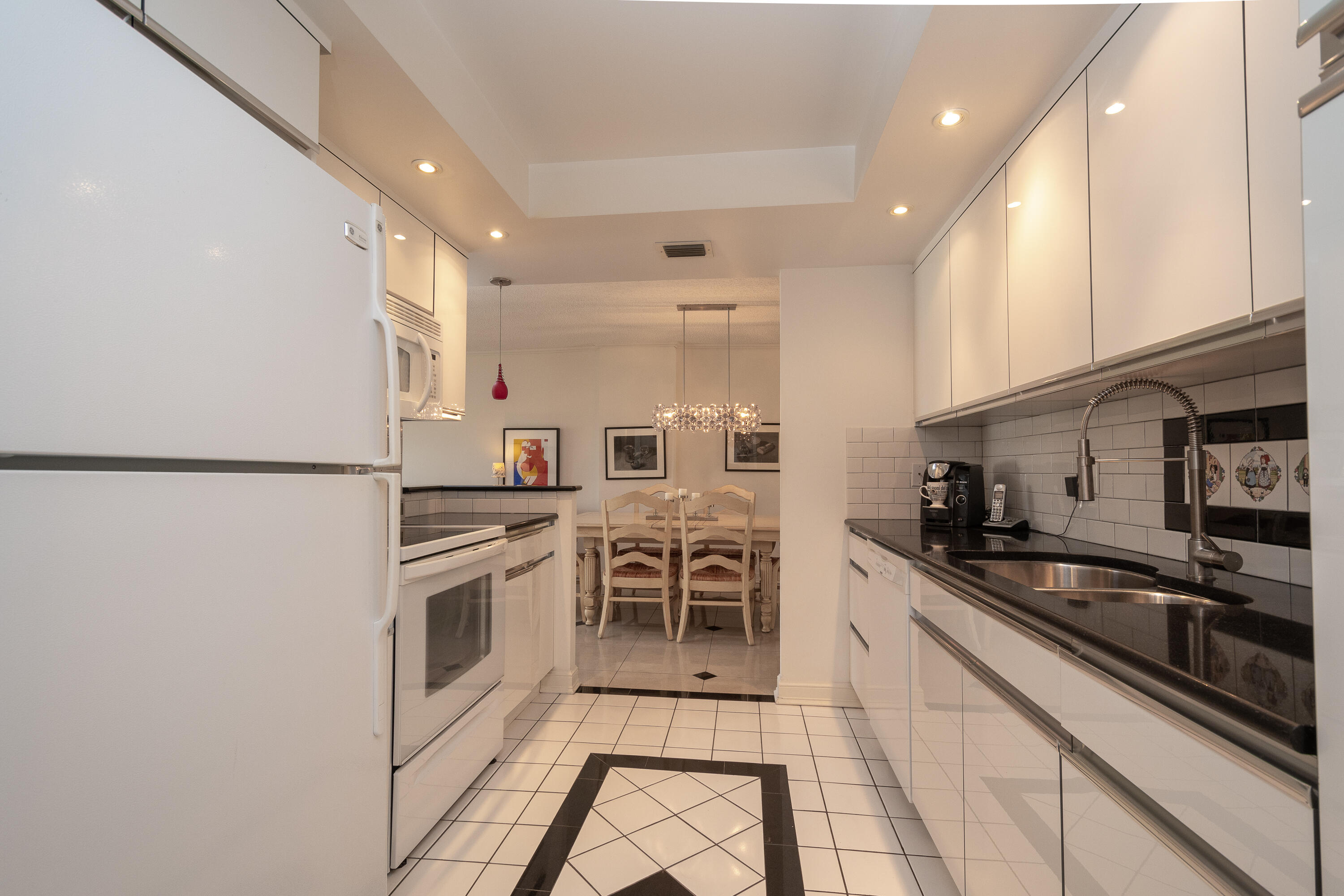 951 De Soto Road, Unit 427 Boca Raton, FL 33432 - Photo 14 of 44 a kitchen with stainless steel appliances granite countertop a sink and cabinets