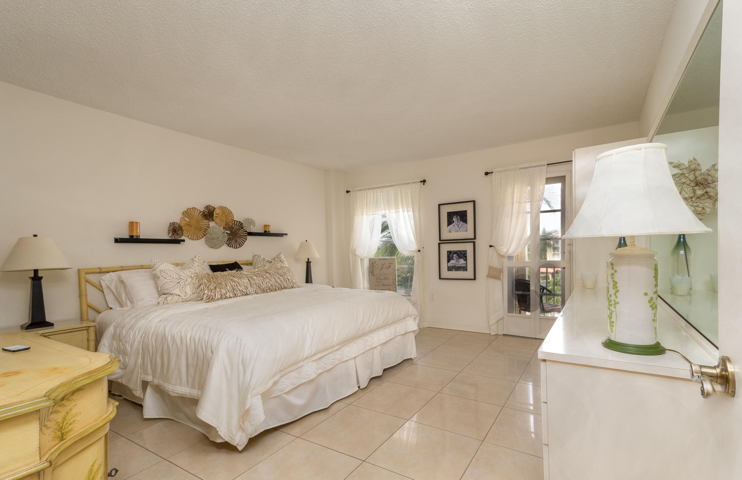 951 De Soto Road, Unit 427 Boca Raton, FL 33432 - Photo 17 of 44 a bedroom with a bed and lamp