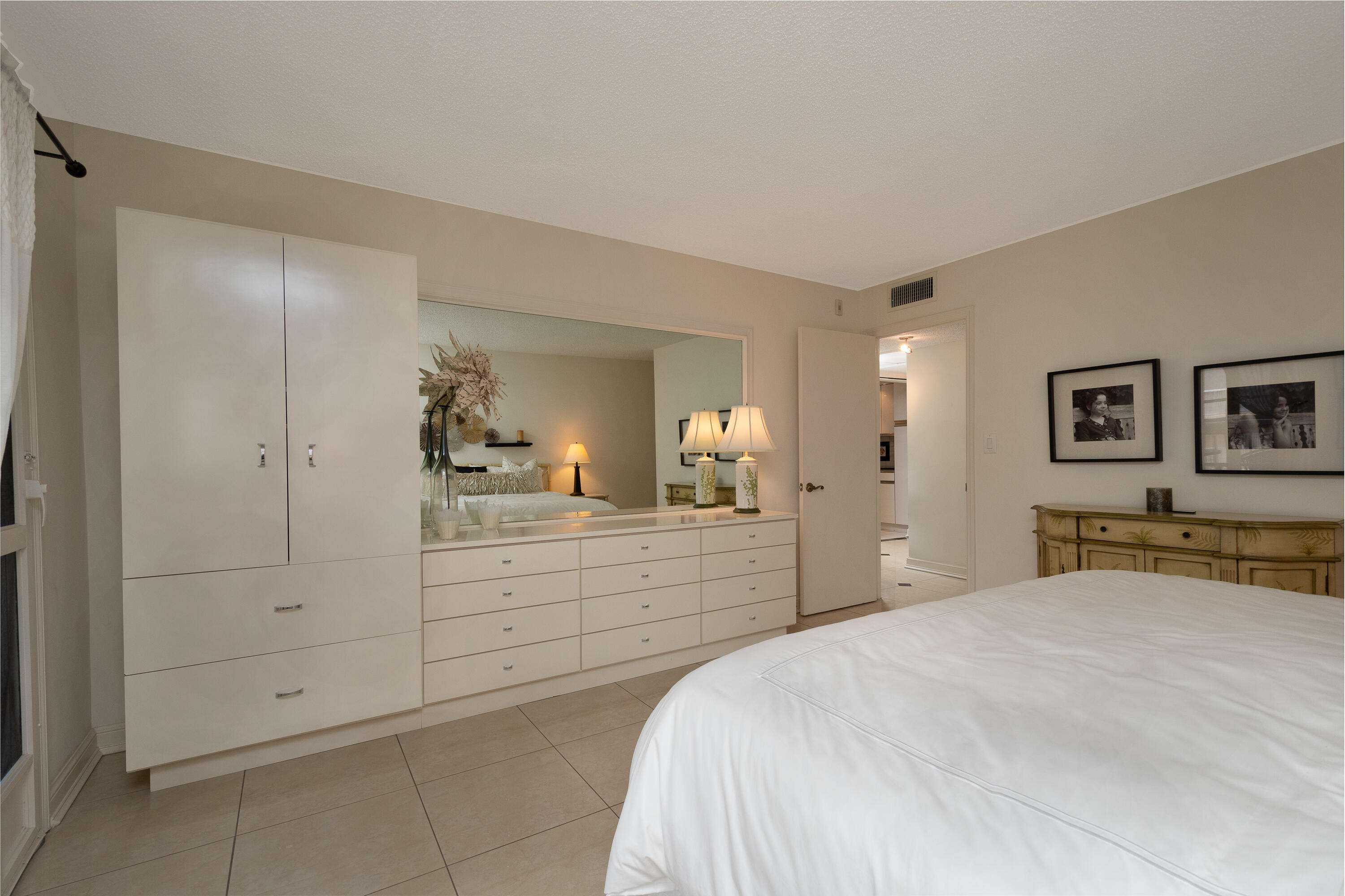 951 De Soto Road, Unit 427 Boca Raton, FL 33432 - Photo 18 of 44 a bedroom with a bed and a dresser