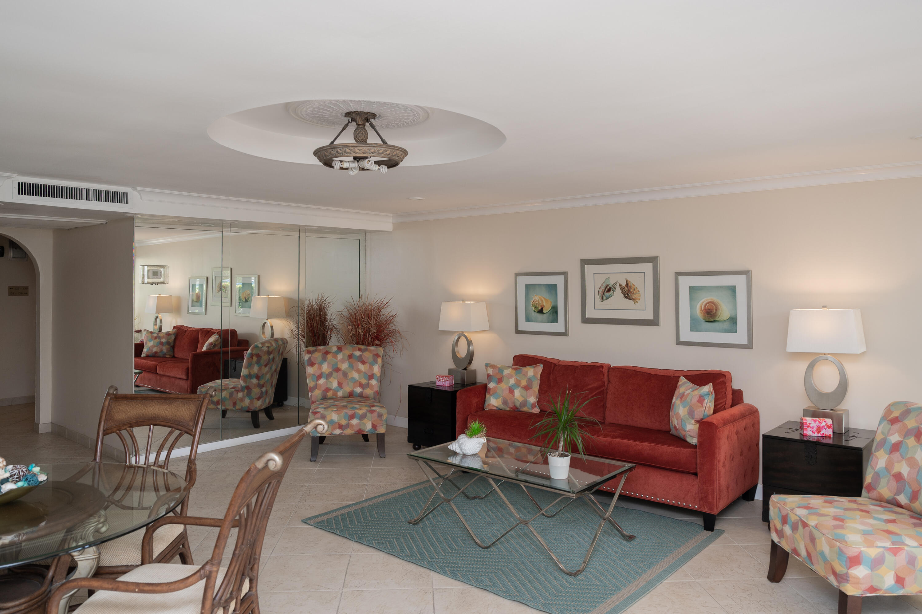 951 De Soto Road, Unit 427 Boca Raton, FL 33432 - Photo 26 of 44 a living room with furniture a chandelier and a window