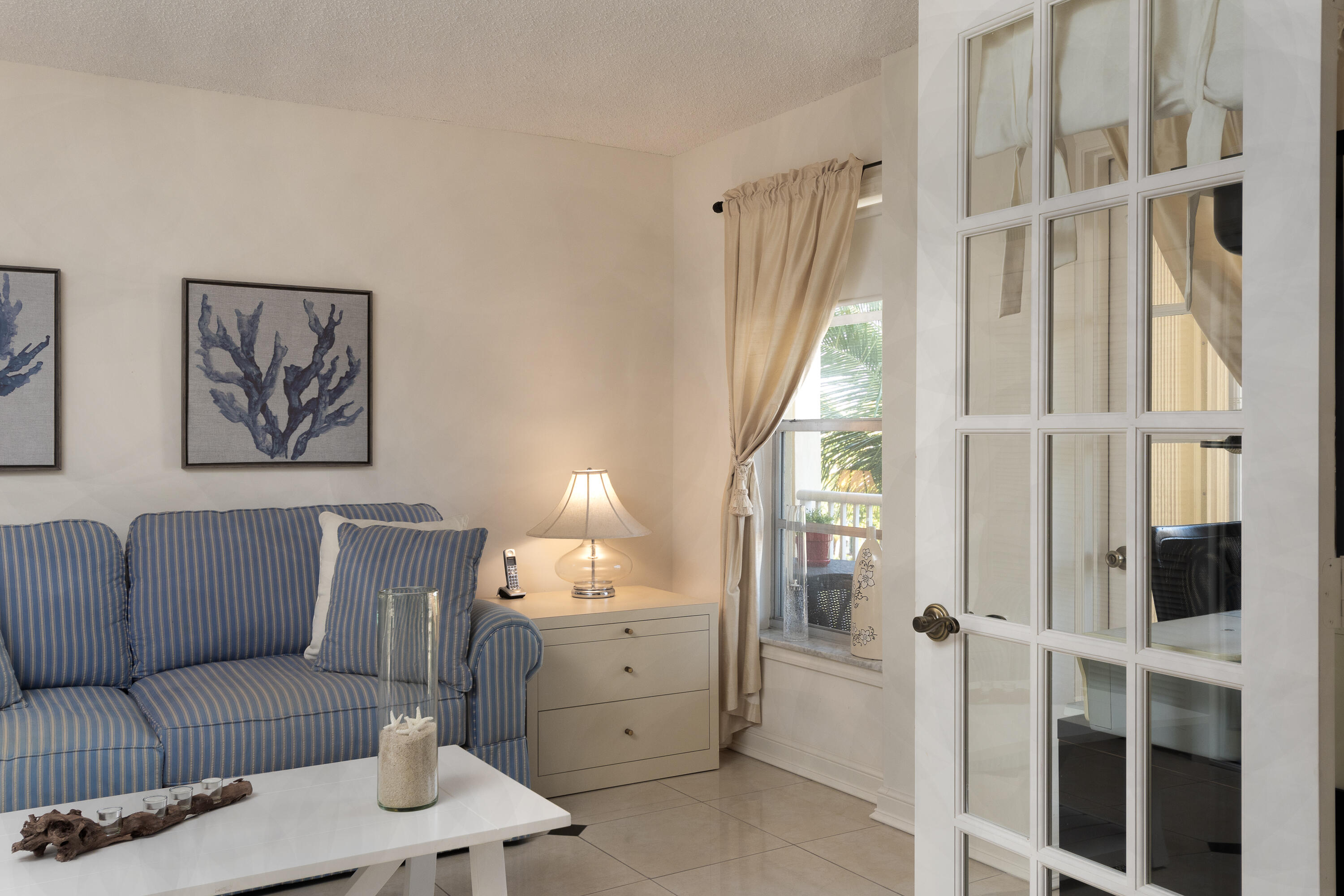 951 De Soto Road, Unit 427 Boca Raton, FL 33432 - Photo 10 of 44 a living room with furniture a flat screen tv and a window