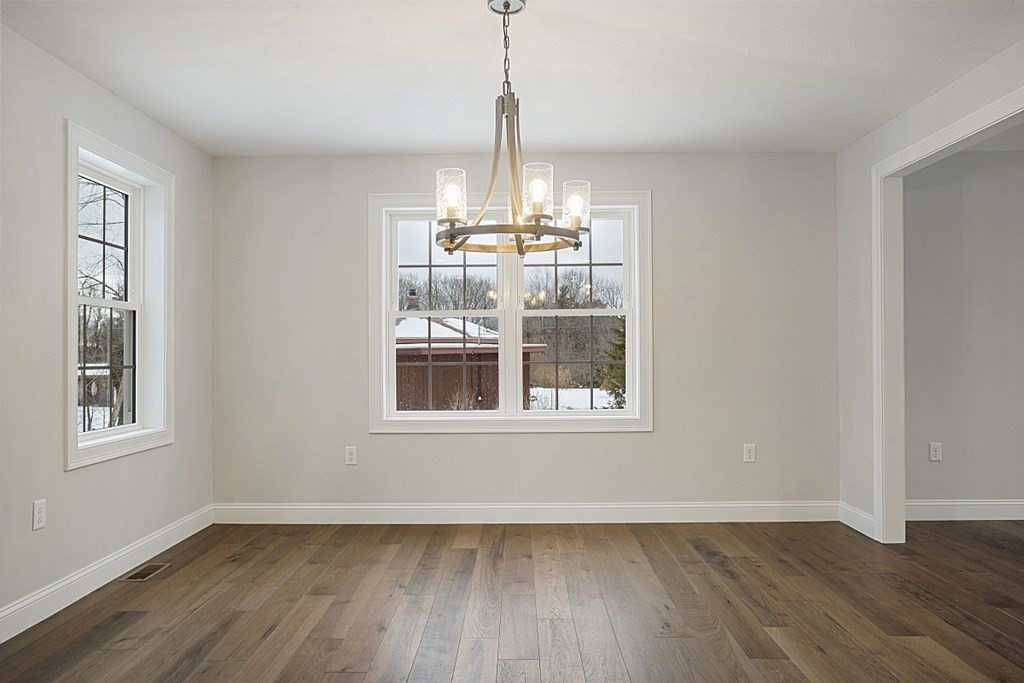 182 Davis Road Westminster, MA 01473 - Photo 13 of 42 a view of an empty room with wooden floor and a window
