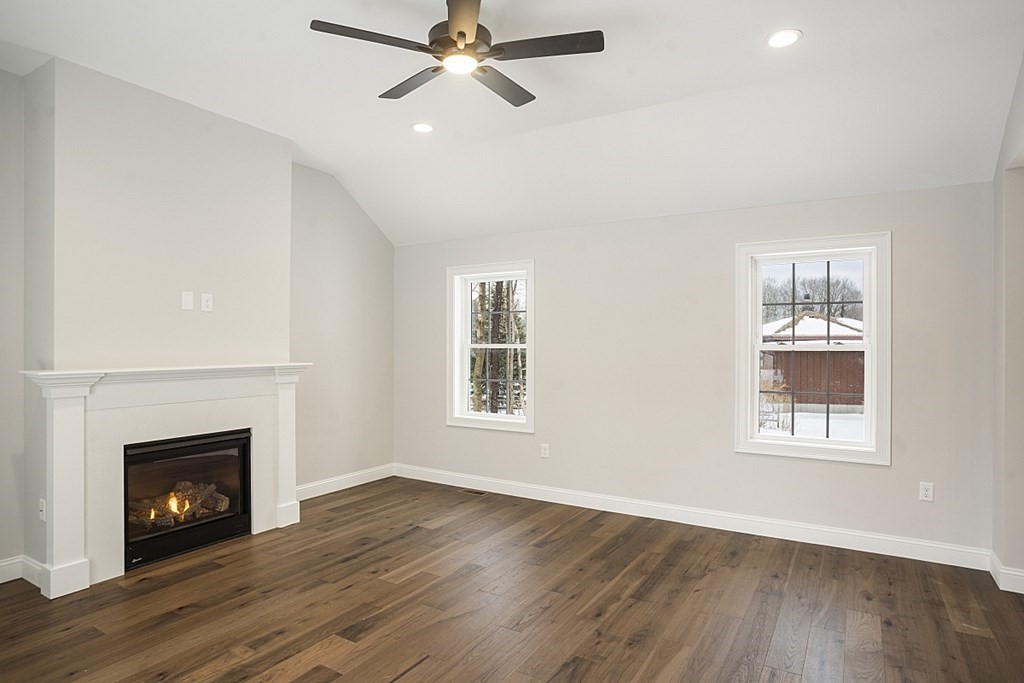 182 Davis Road Westminster, MA 01473 - Photo 19 of 42 a view of an empty room with wooden floor fireplace and a window