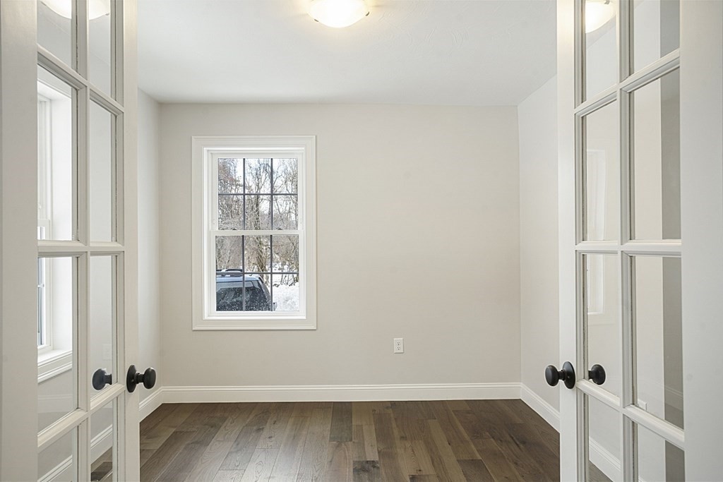 182 Davis Road Westminster, MA 01473 - Photo 24 of 42 an empty room with wooden floor and windows
