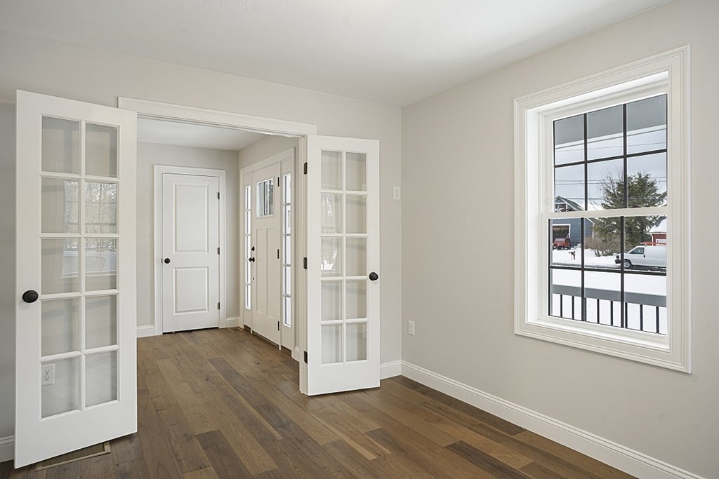 182 Davis Road Westminster, MA 01473 - Photo 25 of 42 an empty room with wooden floor and windows