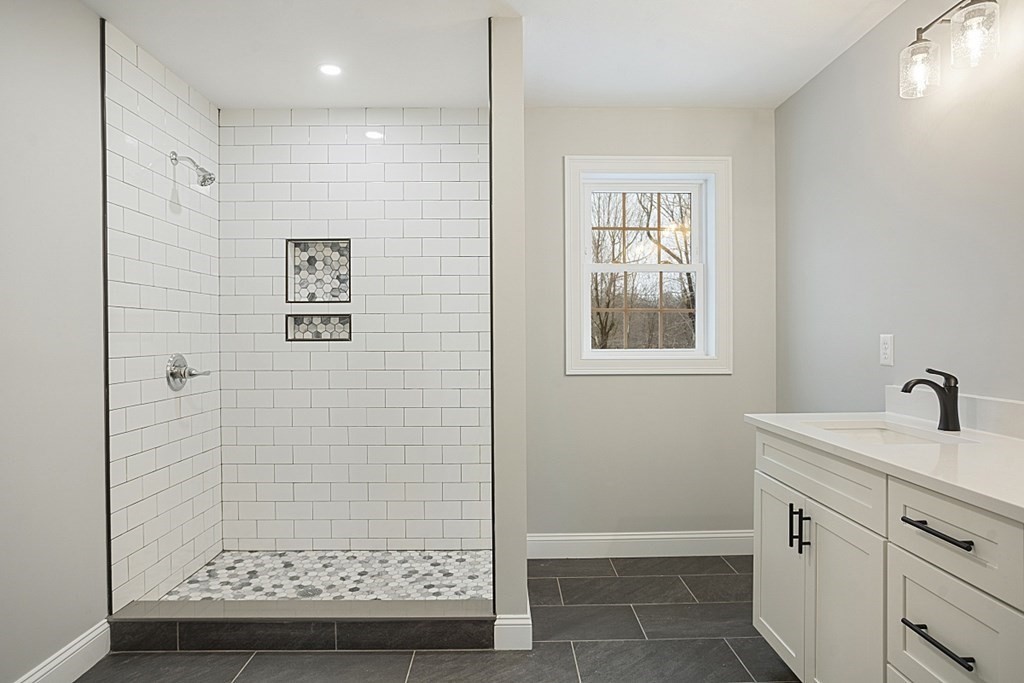 182 Davis Road Westminster, MA 01473 - Photo 30 of 42 a bathroom with a sink a mirror and a shower