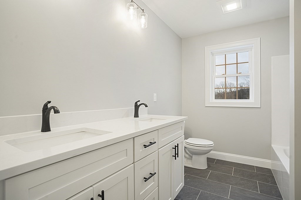 182 Davis Road Westminster, MA 01473 - Photo 34 of 42 a bathroom with a sink a toilet and a mirror