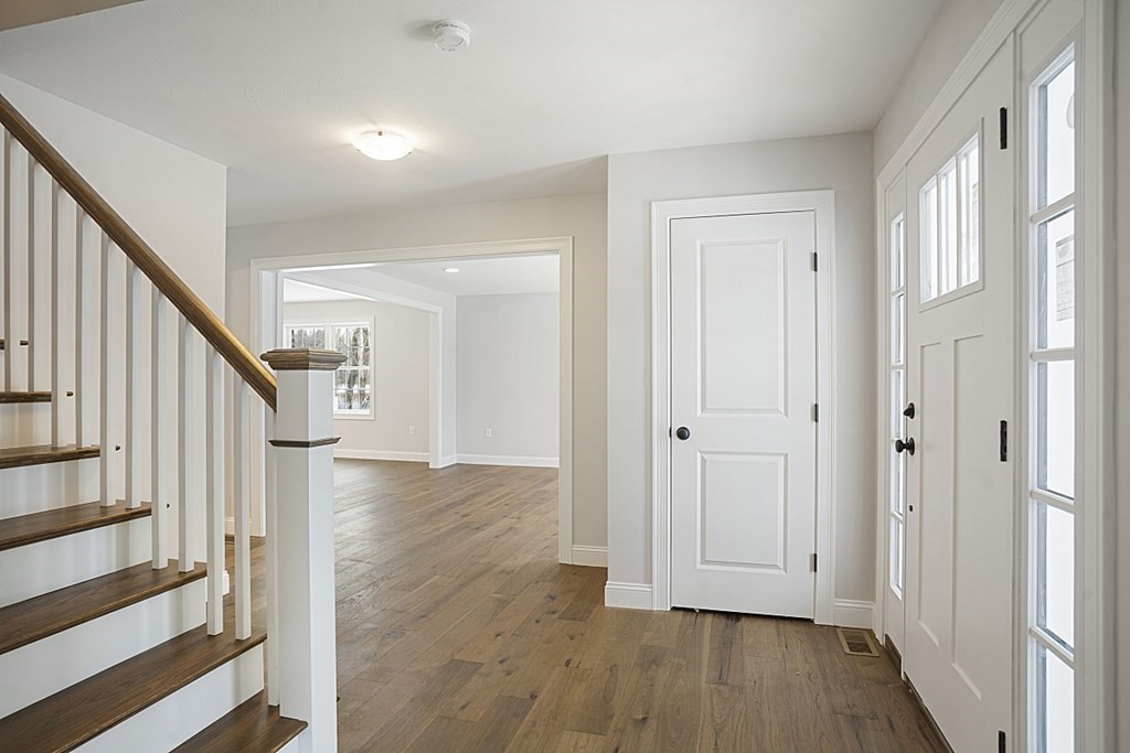 182 Davis Road Westminster, MA 01473 - Photo 6 of 42 a view of a hallway with wooden floor and staircase