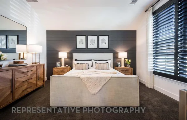 a bed room with a bed and a chair