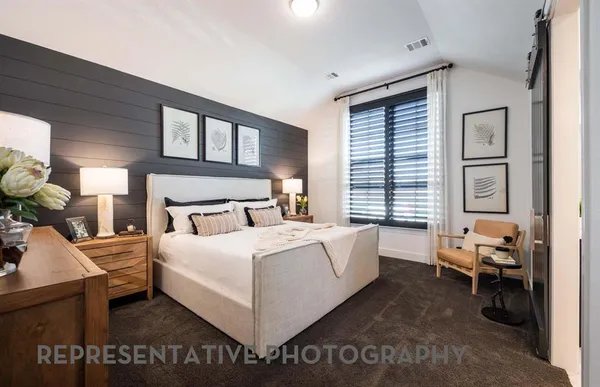 a large bedroom with a bed and a large window