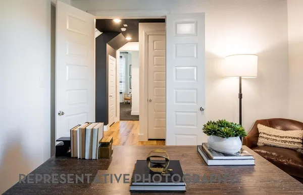 a bedroom with a bed and a lamp on table