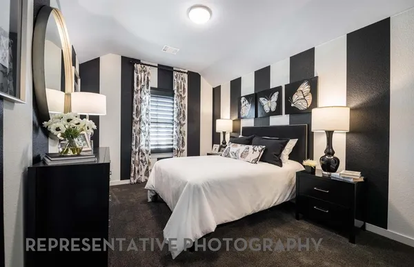 a bedroom with a bed and a night stand