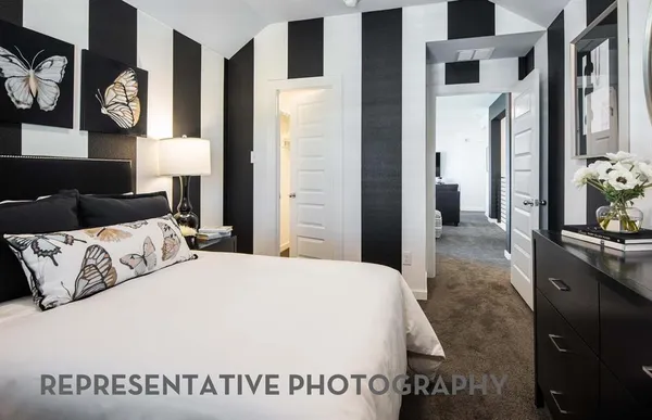 a living room with furniture and floor to ceiling windows