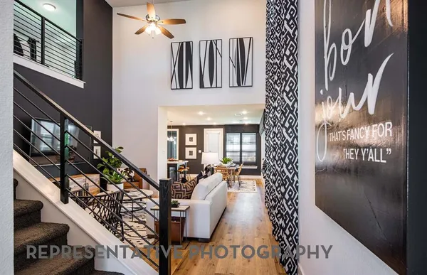 a picture of a living room with furniture and wooden floor