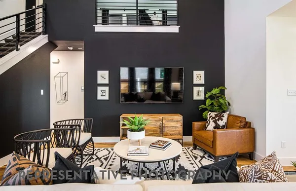 a living room with furniture and a potted plant