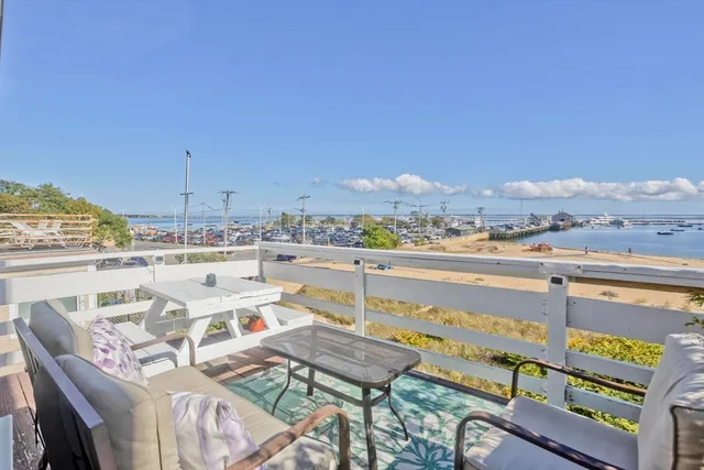 a living room with furniture a rug and a chandelier